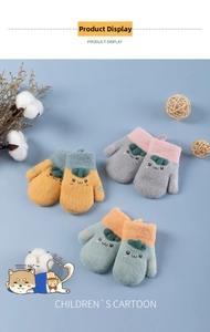 Detailed view of thick knit winter gloves for kids with cartoon faces and leaf decor