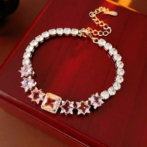 Macro detail of silver tennis bracelet with pink square stones on luxury wooden box