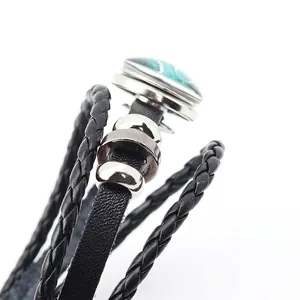 Steampunk leather bracelet featuring glowing dragon eye charm and woven rope layers