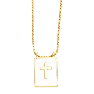 Gold rectangular cross pendant necklace with white enamel finish on a fine chain