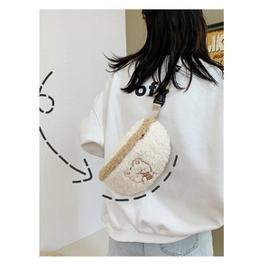 Detailed view of white plush crossbody bag with cute bear embroidery texture