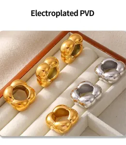 Detail of PVD electroplated gold and silver flower rings in a velvet jewelry box