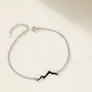 Minimalist silver chain bracelet featuring a black mountain charm for couples