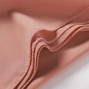 Detailed close-up of premium chiffon fabric with reinforced stitching in dusty pink color