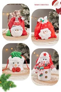 Close-up of four Christmas drawstring gift bags featuring Santa and Snowman plush designs