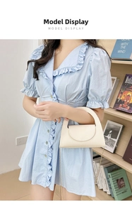 Mini cream lychee pattern handbag with round handle and gold chain strap on model