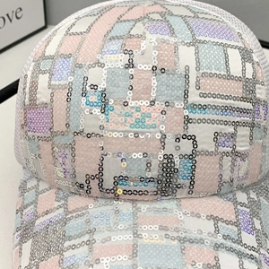 Close-up of sparkling colorful sequins and stitching on a breathable mesh baseball cap