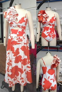 One-piece swimsuit with ruffle shoulder and matching floral skirt in orange floral print