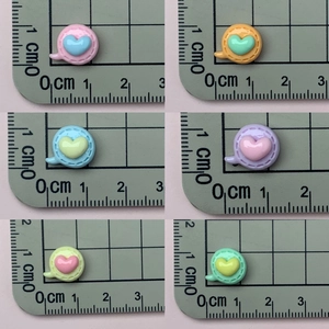 Macro view of 1cm colorful resin heart charms for nail art and jewelry making