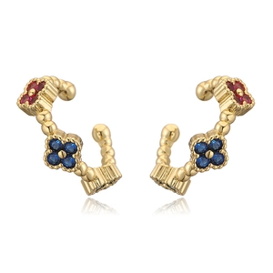 Detail of clover ear cuffs with colorful gemstones and vintage golden beaded texture