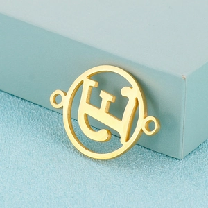 Detailed macro view of a gold-plated circular pendant with Arabic calligraphy design
