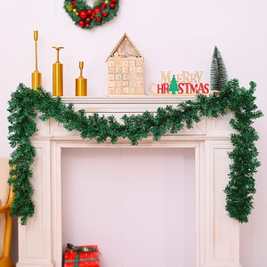 Lush 2.7m frosted green Christmas garland decorated on a white fireplace mantel