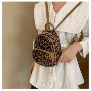 Detail of leopard print mini backpack with soft texture and leather shoulder straps