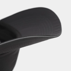 Detailed macro shot of reinforced stitching on a black quick-dry nylon baseball cap brim