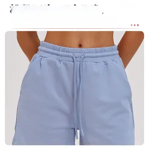 Detail of high waisted light blue sports shorts with elastic waistband and matching drawstrings