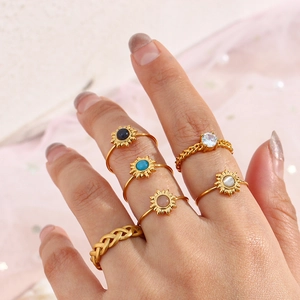 Detailed shot of a bohemian 6-piece gold ring set featuring colorful sun flower designs