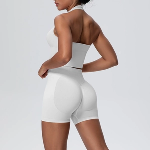 Rear view of white halter yoga bra and high-waist booty lifting shorts for fitness