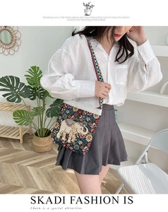 Ethnic style canvas crossbody bag featuring colorful elephant embroidery and woven strap