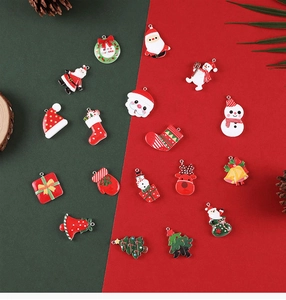 Flat lay of 18 assorted Christmas alloy charms including Santa, elk, and trees