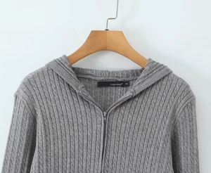 Close-up of the grey cable knit hooded cardigan showing thick textured wool detail