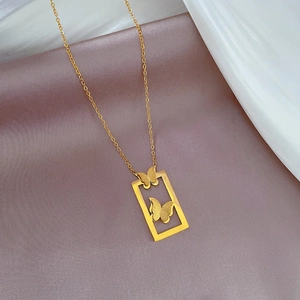 Detail of gold titanium butterfly necklace on soft silk with rectangle pendant