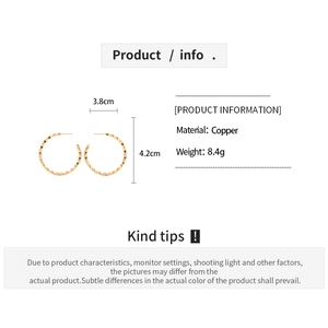Detailed view of golden copper hoop earrings with geometric facets and size specifications