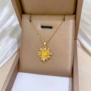 Champagne gold sunflower necklace with yellow crystal on elegant white silk background