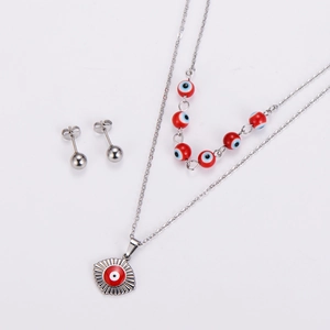 Detail of silver double-layer necklace with red evil eye beads and matching stud earrings
