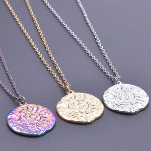 Detailed view of sun pattern charms in gold, silver, and rainbow plated stainless steel