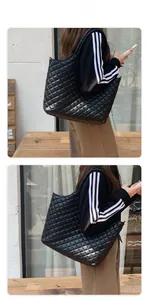 Detail showing classic quilted diamond pattern on high-capacity black tote bag texture