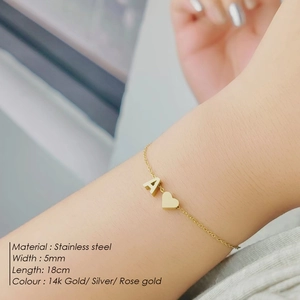 Close-up of 5mm stainless steel bracelet with letter A and heart charms on wrist