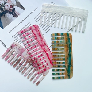 Set of four stylish marble texture acetate wide-tooth hair combs in various colors