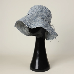 Handmade crochet wide brim sun hat with blue and white woven texture on a display stand