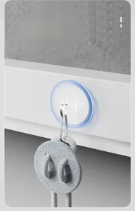 Macro view of a heavy-duty traceless adhesive hook hanging a grey woven item