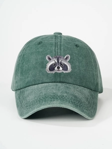 Close-up of raccoon embroidery on washed dark green cotton canvas baseball cap