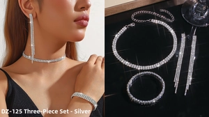 Detailed view of silver rhinestone jewelry set with tassel earrings and choker