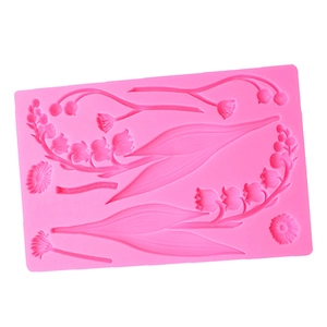 Detail of pink silicone mold featuring lily of the valley and daisy floral textures