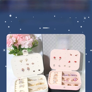 Detail view of pink and white travel jewelry organizers with multi-grid interior storage