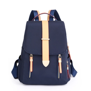 Navy blue oxford fabric travel backpack with contrasting beige straps and gold hardware