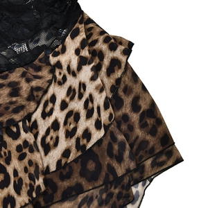 Close-up of layered ruffles with black lace and leopard print fabric detail on the dress