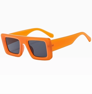 Side view of trendy orange square frame sunglasses with dark grey lenses on white background