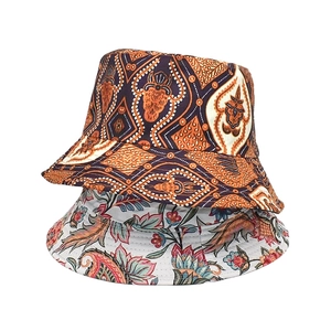 Detailed view of printed bucket hats showing ethnic patterns and floral canvas textures