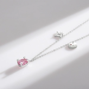 S925 Sterling Silver Gemini necklace featuring a pink teardrop gemstone and silver charms