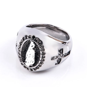 Macro detail of silver hip hop ring featuring Virgin Mary relief and set with small zircons