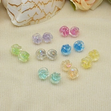 Flat lay of colorful resin rose charms for DIY jewelry making in various translucent tones