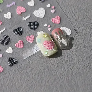 Detail of 3D embossed heart nail stickers with macaron patterns and textured 3D relief effects
