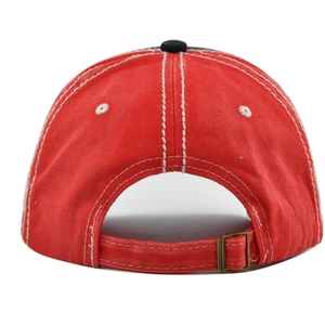 Detail of red washed vintage baseball cap back with metal buckle and white stitching