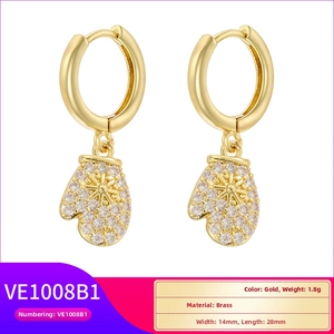Detailed view of gold brass Christmas glove earrings with sparkling star and rhinestone inlay