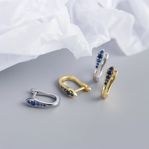 Macro shot showing 925 silver hallmark and blue zircon on U-shaped hoop earrings