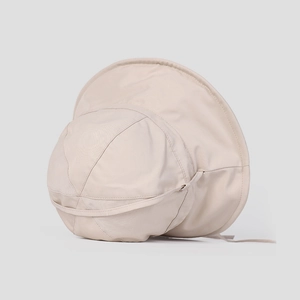 Detail of beige sun hat featuring wide brim and adjustable windproof strap for women
